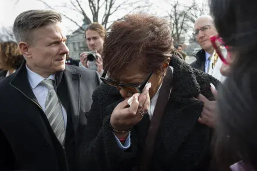 Pamela Walker, mother of Jayland Walker, who was shot and killed by police in Akron, Ohio, is comforted prior to appearing before reporters about police reform, on Capitol Hill in Washington, on Feb. 7, 2023. (AP Photo/Cliff Owen, File)