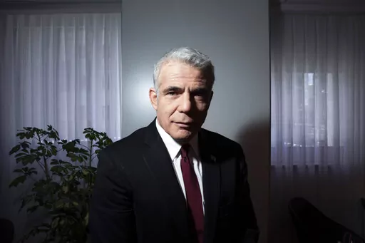 Israel's opposition leader Yair Lapid poses for a photo at his office in Tel Aviv, Israel, Thursday, May 21, 2020. Following the government's decision to dissolve parliament, Lapid, now foreign minister, is set to take office as caretaker prime minister until elections in the fall. It will be a critical test for Lapid, 58, who will try to convince Israelis he is worthy of the top office as he takes on a resurgent Netanyahu. (AP Photo/Oded Balilty, File)