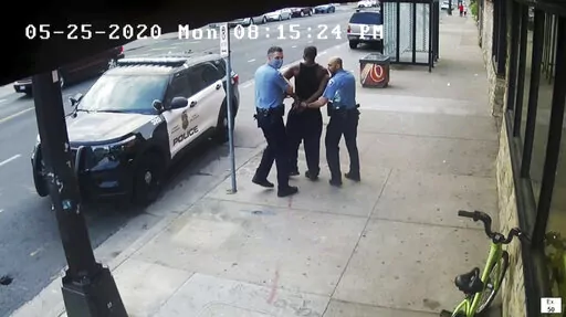 This image from video shows Minneapolis Police Officers Thomas Lane, left and J. Alexander Kueng, right, escorting George Floyd, center, to a police vehicle outside Cup Foods in Minneapolis, on May 25, 2020. The two and another former Minneapolis officers are on trial in February 2022, on federal civil rights charges in Floyd's death. All three are expected to testify. Kueng took the stand Wed. Feb. 16, 2022 in the trial. (Court TV via AP, Pool, File)