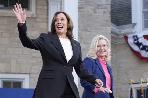 Democratic presidential nominee Vice President Kamala Harris, left, arrives to speak at a campaign event with former Congresswoman Liz Cheney, R-Wyo., right, at Ripon College in Ripon, Wis., Thursday, Oct. 3, 2024. (AP Photo/Mark Schiefelbein)