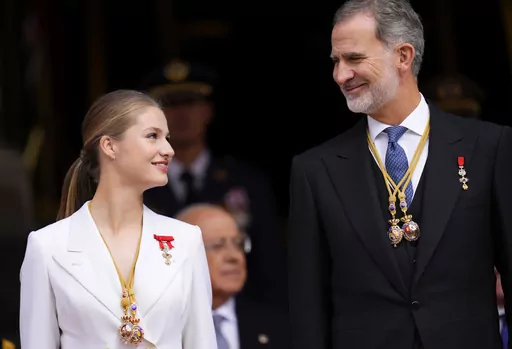 Princess Leonor looks a her father, the Spanish King Felipe VI as they attend a military parade after swearing allegiance to the Constitution during a gala event that makes her eligible to be queen one day, in Madrid on Tuesday, Oct. 31 2023. The heir to the Spanish throne, Princess Leonor, has sworn allegiance to the Constitution on her 18th birthday. Tuesday's gala event paves the way to her becoming queen when the time comes. Leonor is the eldest daughter of King Felipe and Queen Letizia. (AP