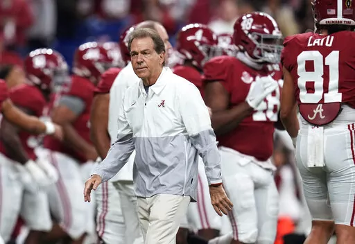 Alabama coach Nick Saban watches players warm up for the College Football Playoff championship NCAA football game against Georgia on Jan. 10, 2022, in Indianapolis. Saban called out Texas A&M on Wednesday night, May 18 for “buying” players in its top-ranked recruiting class with name, image and likeness deals, saying Crimson Tide football players earned more than $3 million last year “the right way.” (AP Photo/Paul Sancya, File)