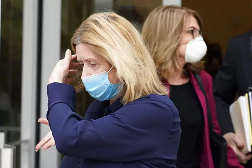 Nancy New, left, president of New Learning Resources, leaves the federal courthouse in Jackson, Miss., on Thursday, March 18, 2021. On Wednesday, April 20, 2022, she pleaded guilty to a federal wire fraud charge. Prosecutors said the company improperly obtained millions of dollars from the state of Mississippi.  (AP Photo/Rogelio V. Solis, File)