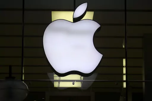 The Apple logo is illuminated at a store in the city center of Munich, Germany, Dec. 16, 2020. Apple Inc. is raising the prices for its AppleTV+ streaming and Arcade gaming plans, as well as its bundled Apple One service that includes streaming, music and other subscriptions. (AP Photo/Matthias Schrader, File)