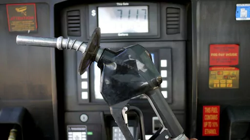 A gasoline pump is shown at a gas station Friday, June 10, 2022, in Salt Lake City.  With record-high gas prices, travelers can save money on summer road trips by considering alternatives. They can plan a trip to U.S. regions with lower-cost fuel, like the Midwest or South. If travelers need to rent a car, they might find affordable options by going to a cheaper car rental location or considering a car rental alternative like car sharing. With more hotels offering electric vehicle charging, rent