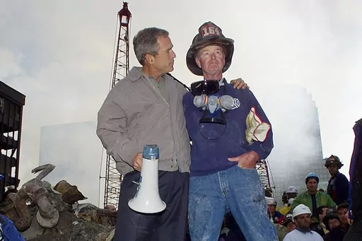 FILE — As rescue efforts continue in the rubble of the World Trade Center in New York, President George W. Bush, left, stands with New York City firefighter Bob Beckwith on a burnt fire truck in front of the World Trade Center during a tour of the devastation, Sept. 13, 2001. Beckwith, who became part of an iconic image of American unity after the Sept. 11 terrorist attacks, has died at age 91. The retired firefighter died Sunday night, Feb. 4, 2024, in hospice care after dealing with cancer i