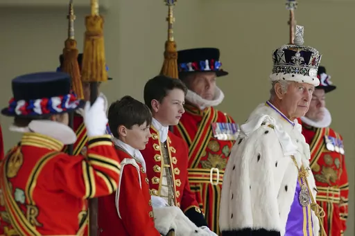 Britain's King Charles III, right, arrives to receive a royal salute from members of the military in the gardens of Buckingham Palace, following his coronation, in London, Saturday May 6, 2023. A year after the death of Queen Elizabeth II triggered questions about the future of the British monarchy, King Charles III’s reign has been marked more by continuity than transformation, by changes in style rather than substance. (Peter Byrne/Pool Photo via AP, File)