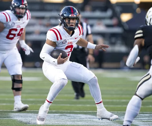 Mississippi quarterback Jaxson Dart (2) scrambles past the Vanderbilt defense during the third quarter of an NCAA college football game Saturday, Oct. 8, 2022, in Nashville, Tenn. (George Walker IV/The Tennessean via AP)
