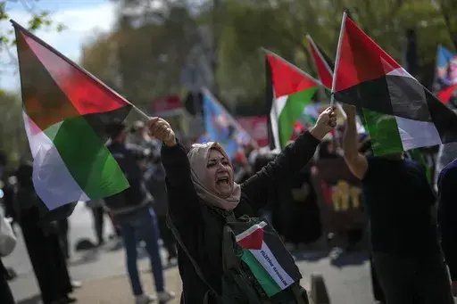A woman waves flags in support of Palestinians in Gaza during a protest in Istanbul, Turkey, Friday, April 5, 2024. Turkey and Israel announced tit-for-tat trade barriers on Tuesday, April 9, 2024, as relations between them further deteriorated amid the war in Gaza. Turkey, a staunch critic of Israel’s military actions in Gaza, first announced that it was restricting exports of 54 types of products to Israel with immediate effect. The products include aluminum, steel, construction products, je