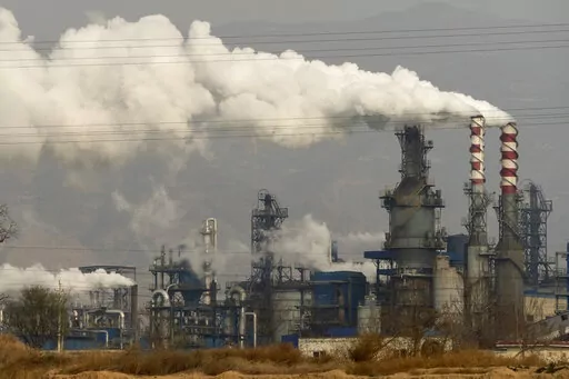 In this Nov. 28, 2019, file photo, smoke and steam rise from a coal processing plant in Hejin in central China's Shanxi Province. The International Energy Agency said Wednesday that emissions of planet-warming methane from oil, gas and coal production are significantly higher than governments claims. The countries with the highest emissions are China, Russia, the United States, Iran and India, the IEA said. (AP Photo/Olivia Zhang, File)