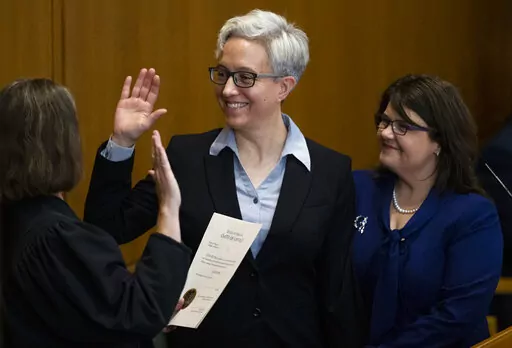 Tina Kotek, center, was accompanied by her wife Aimee Wilson, right, as Kotek was sworn in as Oregon governor at the state Capitol building in Salem, Ore., on Monday, Jan. 9, 2023. (Dave Killen/The Oregonian via AP, Pool)