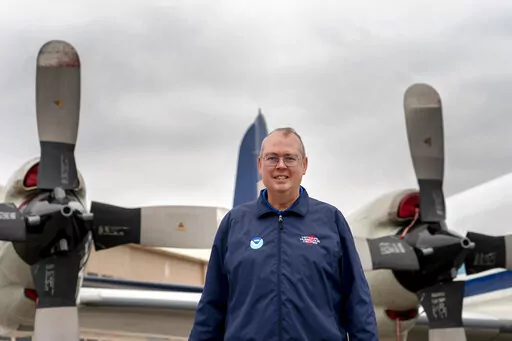 National Hurricane Center Director Ken Graham poses for a portrait in front of WP-3D Orion "hurricane hunter" aircraft during a hurricane awareness tour at Washington National Airport, Arlington, Va., May 3, 2022. The National Oceanic and Atmospheric Administration on Tuesday, June 7, named Graham the overall boss of the weather service. (AP Photo/Gemunu Amarasinghe, File)