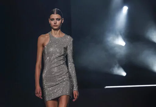 Fashion from Michael Kors' fall/winter 2022 collection is modeled during Fashion Week, Tuesday, Feb. 15, 2022, in New York. (AP Photo/Bebeto Matthews)