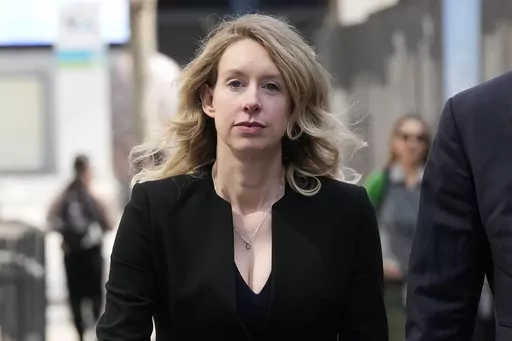 Former Theranos CEO Elizabeth Holmes leaves federal court in San Jose, Calif., March 17, 2023. Holmes has asked a federal judge, Wednesday, May 17, 2023, to allow her to remain free through the Memorial Day weekend before surrendering to authorities on May 30, to begin her more than 11-year prison sentence for defrauding investors in a blood-testing scam. (AP Photo/Jeff Chiu, File)