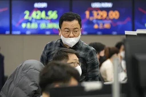 Currency traders watch monitors at the foreign exchange dealing room of the KEB Hana Bank headquarters in Seoul, South Korea, Wednesday, Nov. 30, 2022. Asian shares were mostly lower Wednesday ahead of a closely watched speech by the Federal Reserve chief that may give clues about future interest rate hikes. (AP Photo/Ahn Young-joon)