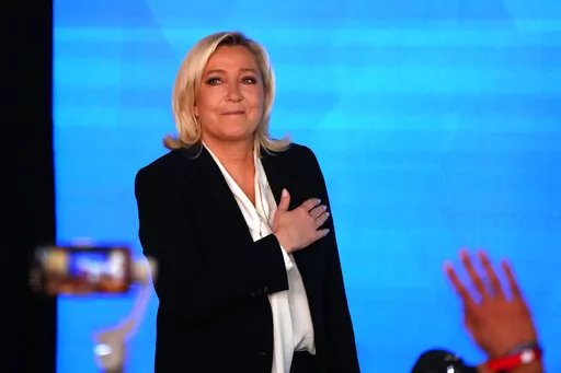 Far-right leader Marine Le Pen gestures as she arrives to speak after the early result projections of the French presidential election runoff were announced in Paris, Sunday, April 24, 2022. French polling agencies are projecting that centrist incumbent Emmanuel Macron will win France's presidential runoff Sunday, beating far-right rival Marine Le Pen in a tight race that was clouded by the Ukraine war and saw a surge in support for extremist ideas. (AP Photo/Francois Mori)