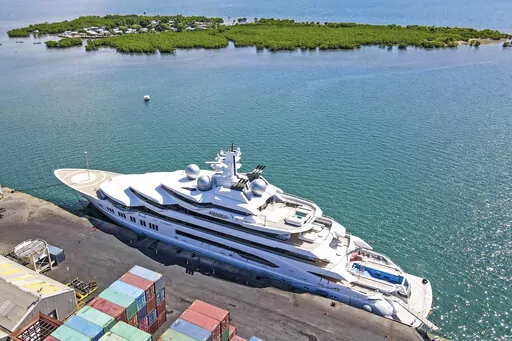 The superyacht Amadea is docked at the Queens Wharf in Lautoka, Fiji, on April 15 2022. On May 5, five U.S. federal agents boarded the massive Russian-owned superyacht Amadea that was berthed in Lautoka harbor in Fiji in a case that is highlighting the thorny legal ground the U.S. is finding itself on as it tries to seize assets of Russian oligarchs around the world. (Leon Lord/Fiji Sun via AP, File)