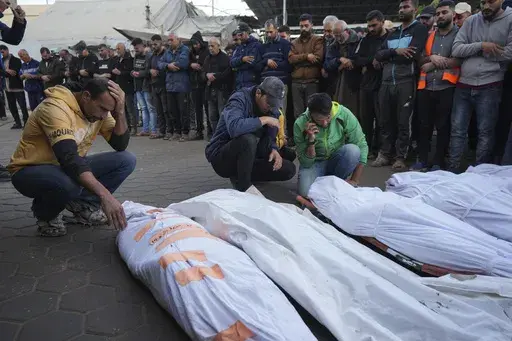 Palestinians mourn their relatives killed in the Israeli bombardment of Maghazi in the Gaza Strip, during their funeral at a hospital morgue in Deir al-Balah, Gaza, Thursday, Nov. 14, 2024. (AP Photo/Abdel Kareem Hana, File)