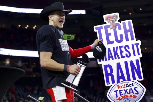 Texas Tech quarterback Tyler Shough waves a sign after the team's 42-25 win over Mississippi in the Texas Bowl NCAA college football game, early Thursday, Dec. 29, 2022, in Houston. (AP Photo/Michael Wyke)