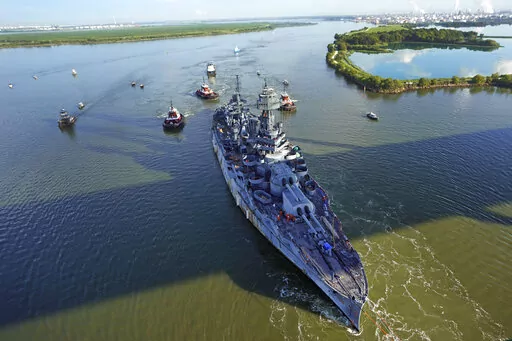 The USS Texas is towed down the Houston Ship Channel Wednesday, Aug. 31, 2022, in Baytown, Texas. The vessel, which was commissioned in 1914 and served in both World War I and World War II, is being towed to a dry dock in Galveston where it will undergo an extensive $35 million repair. (AP Photo/David J. Phillip)