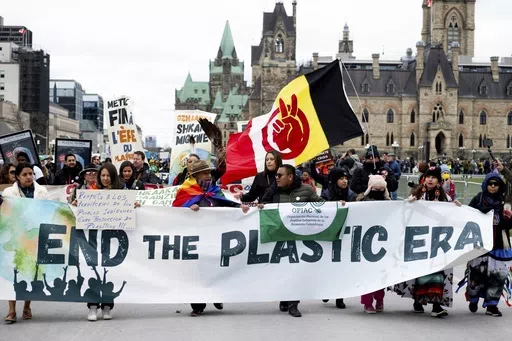 People participate in a March to End the Plastic Era on Parliament Hill in Ottawa, Ontario, on April 21, 2024. (Spencer Colby/The Canadian Press via AP, File)
