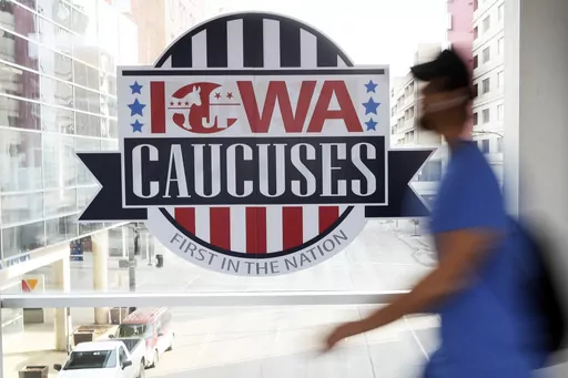 A pedestrian walks past a sign for the Iowa Caucuses on a downtown skywalk, in Des Moines, Iowa, on Feb. 4, 2020. Iowa Republicans have scheduled the party’s presidential nominating caucuses for Jan. 15, 2024, putting the first votes of the next election a little more than six months away. (AP Photo/Charlie Neibergall, File)