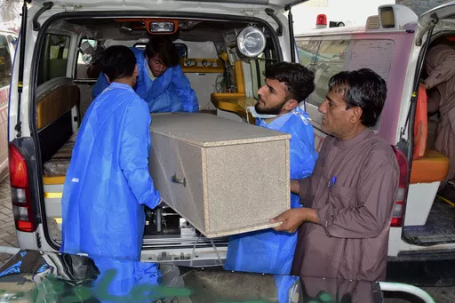 Hospital staff and volunteers unload a casket from an ambulance upon arrival at a hospital in Quetta, Pakistan, Saturday, April 13, 2024. Pakistani police are searching for gunmen who killed eight people after abducting them from a bus on a highway in the country's southwest, a police official said Saturday. Earlier, the same attackers killed two people and wounded six in another car they forced to stop. (AP Photo/Arshad Butt)