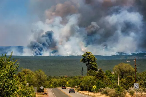 The Calf Canyon/Hermit Peak Fire burns in the mountains near Pecos, N.M., on Thursday May 25, 2022. After scorching more than 530 square miles of the Rocky Mountain foothills, the government-sparked wildfire helped to shine a light on what officials in New Mexico are calling a crisis — where insurance coverage for everything from homes to workers compensation comes at premiums that often make it unobtainable for many in the poverty-stricken state. (Eddie Moore/The Albuquerque Journal via AP, F