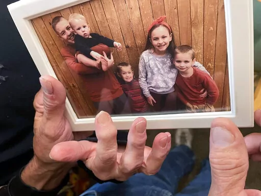 From left, Brian Anthony Nelson II, Kurgan Nelson, Ragnar Nelson, Brantley Nelson and Vegeta Nelson are seen in a framed photograph in their grandparents apartment in Tulsa, Okla., on Friday, Oct. 28, 2022. All six children perished Thursday in what Broken Arrow Police suspect was a murder-suicide by their parents, Brian and Brittney Nelson. (Andrea Eger/Tulsa World via AP)