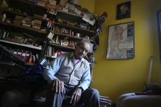 Emilio Barreto, who was imprisoned without charge for 13 years under Gen. Alfredo Stroessner's dictatorship, pauses during an interview at his home in Lambare, Paraguay, Wednesday, Aug. 14, 2024. (AP Photo/Jorge Saenz)