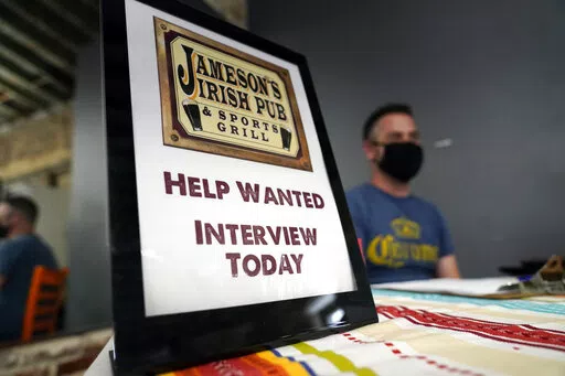 A hiring sign is placed at a booth for Jameson's Irish Pub during a job fair Wednesday, Sept. 22, 2021, in the West Hollywood section of Los Angeles.  In a surprising burst of hiring, America’s employers added 467,000 jobs in January 2022 in a sign of the economy’s resilience even in the face of a wave of omicron infections last month. (AP Photo/Marcio Jose Sanchez, File)