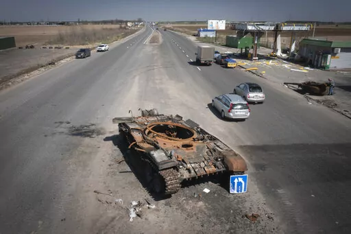 FILE -A Russian tank destroyed in recent fighting is seen on a road to Kyiv, Ukraine, Friday, April 15, 2022.  On Friday, April 22, 2022,  The Associated Press reported on stories circulating online incorrectly claiming a photo of a woman in a military uniform shows a “Ukranian beauty” who “blew up 52 invading Russian tanks.”  (AP Photo/Efrem Lukatsky, File)