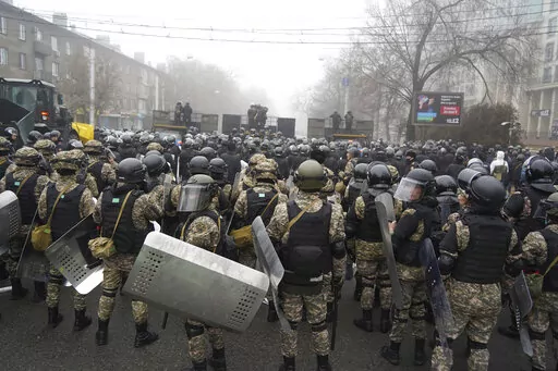 Riot police block a street to prevent demonstrators during a protest in Almaty, Kazakhstan, Wednesday, Jan. 5, 2022. Demonstrators denouncing the doubling of prices for liquefied gas have clashed with police in Kazakhstan's largest city and held protests in about a dozen other cities in the country. (AP Photo/Vladimir Tretyakov)