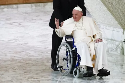 Pope Francis arrives in a wheelchair to attend an audience with nuns and religious superiors in the Paul VI Hall at The Vatican, Thursday, May 5, 2022. Pope Francis, whose mobility has been limited of late by a nagging knee problem, is looking forward to visiting South Sudan in July, according to a joint message by the pontiff, the archbishop of Canterbury and a Scottish church official. (AP Photo/Alessandra Tarantino, File)