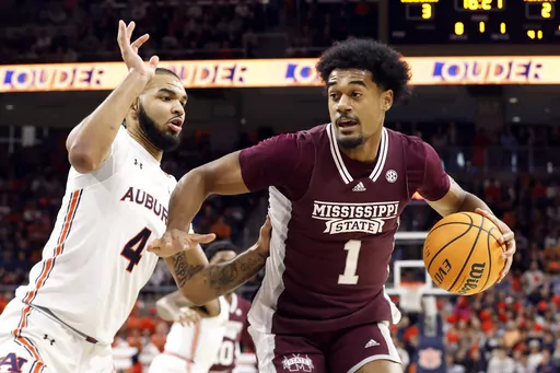 Mississippi State forward Tolu Smith (1) drives to the basket around Auburn forward Johni Broome (4) defends during the first half of an NCAA college basketball game Saturday, Jan. 14, 2023 in Auburn, Ala.. (AP Photo/Butch Dill, File)