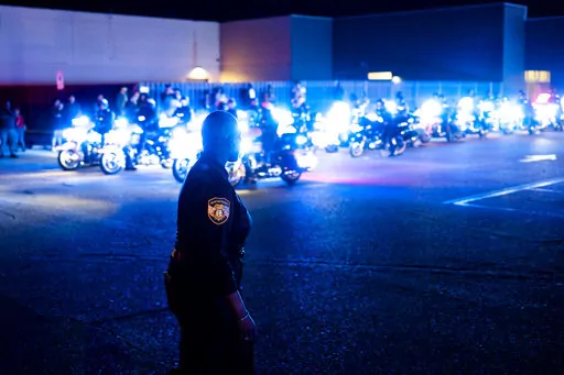 Officers and community members gathered at the beginning of a "Sea of Blue" in honor of fallen officer Geoffrey Redd that directly followed a visitation at Greater Community Temple on Monday, Feb. 27, 2023 in Memphis, Tenn. Redd was shot while responding to a confrontation at a library was remembered at his funeral Tuesday as a strong, proud and dedicated U.S. Marine and public servant. (Brad Vest/Daily Memphian via AP)