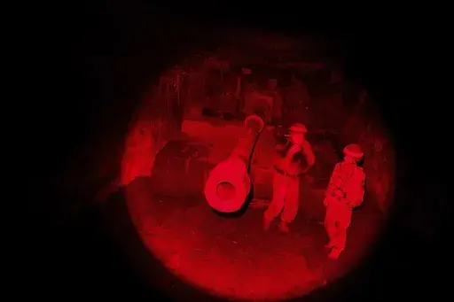 A Ukrainian serviceman of 117th Separate Heavy Mechanized Brigade carries his dog from a AS-90 self-propelled artillery vehicle after firing towards Russian positions at the frontline on Pokrovsk direction, Donetsk region, Ukraine, Wednesday, Dec. 23, 2024. (AP Photo/Evgeniy Maloletka)