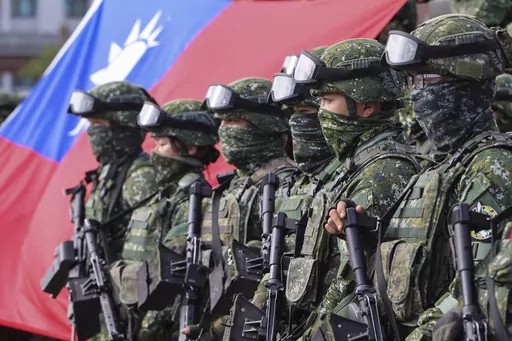 Soldiers pose for group photos with a Taiwan flag after a preparedness enhancement drill simulating the defense against Beijing's military intrusions, ahead of the Lunar New Year in Kaohsiung City, Taiwan on Jan. 11, 2023. Taiwan says 103 Chinese warplanes flew toward the island in new daily high in recent times. Taiwan's Defense Ministry said that it detected the planes in the 24 hours ending at 6 a.m. Monday, Sept. 18, 2023. (AP Photo/Daniel Ceng, File)