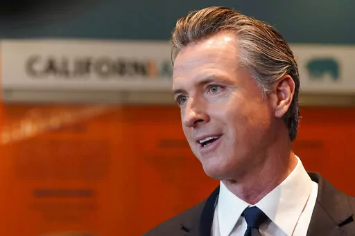 California Gov. Gavin Newsom talks to reporters after voting in Sacramento, Calif., Tuesday, Nov. 8, 2022. Newsom has agreed to release $1 billion in state homelessness funding he testily put on pause earlier this month. But his office says he will do so only if local governments agree to step up the aggressiveness of their plans going forward to reduce homelessness. (AP Photo/Rich Pedroncelli,File)