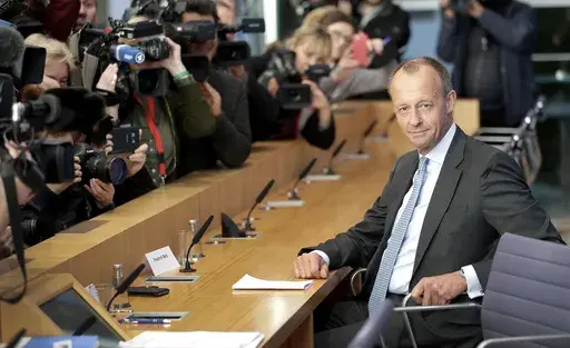 Friedrich Merz, right, member of the German Christian Democratic Party, arrives for a press conference in Berlin, Germany, Oct. 31, 2018. (AP Photo/Michael Sohn, File)