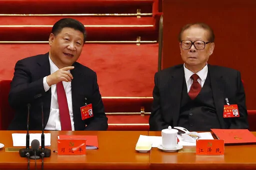 Chinese President Xi Jinping, left, chats with former President Jiang Zemin during the closing ceremony for the 19th Party Congress at the Great Hall of the People in Beijing, on Oct. 24, 2017. With his death, Jiang leaves behind a very different China than the one he tried to shape. Now it’s Xi Jinping’s nation. (AP Photo/Andy Wong, File)