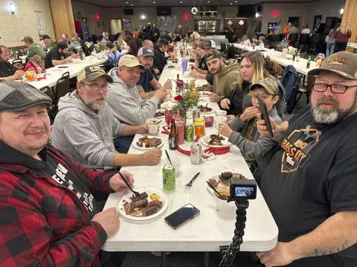 Diners enjoy a wild game dinner that included boar, bobcat and coyote in Pine Grove, Pa.,, on Saturday, Feb. 15, 2025. (AP Photo/Mark Scolforo)