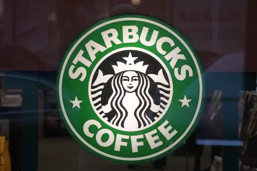 The Starbucks sign is displayed in the window of a Pittsburgh Starbucks, Jan. 30, 2023. On Monday, June 12, jurors in a federal court in New Jersey awarded $25.6 million to a former regional Starbucks manager who alleged that she and other white employees were unfairly punished by the coffee chain after the high-profile 2018 arrests of two Black men at one of the chain's Philadelphia locations. (AP Photo/Gene J. Puskar, File)