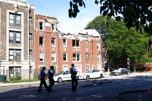 Fire crews respond to the scene of an explosion inside a building on Tuesday, Sept. 20, 2022, in Chicago.  Several people were rushed to hospitals after being injured when an explosion on Tuesday morning tore through the top floor of an apartment building on Chicago's West Side and the fire department was requesting help to search the building, officials said.  (Anthony Vazquez/Chicago Sun-Times via AP)