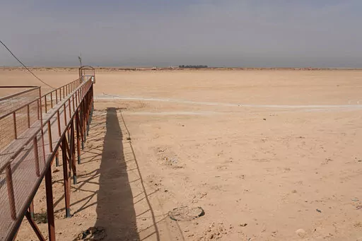 A general view of the dried up Lake Sawa Iraq, is seen Saturday, June 4, 2022. This year, for the first time in its centuries-long history, Sawa Lake dried up completely. A combination of mismanagement by local investors, government neglect and climate change has ground down its azure shores to chunks of salt. (AP Photo/Hadi Mizban)