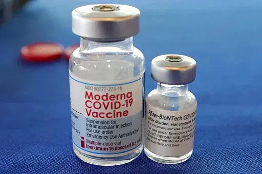 This Sept. 21, 2021 file photo shows vials of the Pfizer and Moderna COVID-19 vaccines in Jackson, Miss. Moderna is suing its main competitors Pfizer and the German drugmaker BioNTech, accusing the rivals of copying Moderna’s technology in order to make their own vaccine. Moderna said Friday, Aug. 26, 2022, that Pfizer and BioNTech’s vaccine Comirnaty infringes on patents Moderna filed several years ago protecting the technology behind its preventive shot, Spikevax.  (AP Photo/Rogelio V. Sol