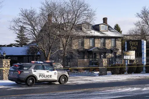 Police attend the scene of a shooting at a pub in Toronto, Canada, Saturday, March 8, 2025. (Arlyn McAdorey/The Canadian Press via AP)