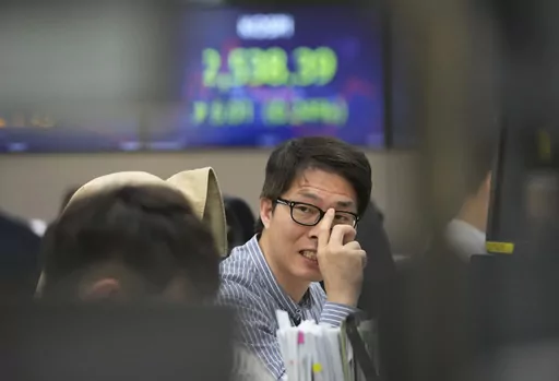 A currency trader works at the foreign exchange dealing room of the KEB Hana Bank headquarters in Seoul, South Korea, Monday, April 24, 2023. Asian stock markets were mixed Monday ahead of a U.S. economic update this week that is expected to show growth slowing. (AP Photo/Ahn Young-joon)