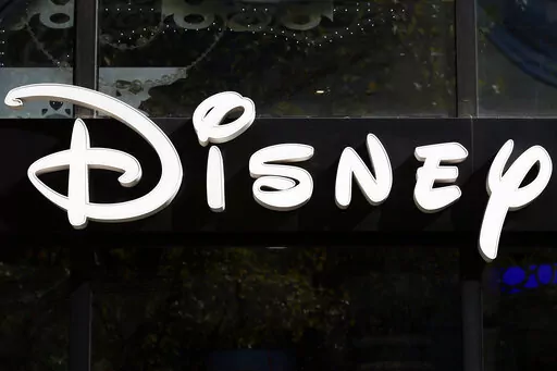 This Sept. 20, 2017, file photo shows a sign at the Disney store on the Champs Elysees Avenue in Paris, France.  The Supreme Court’s decision to end the nation’s constitutional protections for abortion has catapulted businesses of all types into the most divisive corner of politics. A rash of iconic names including The Walt Disney Company, Facebook parent Meta, and Goldman Sachs announced they would pay for travel expenses for those who want the procedure but can't get it in the states they 