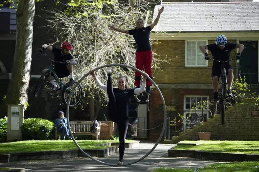Performers from Cirque Bijou pose for photographers after a press conference to unveil the Platinum Jubilee Pageant to mark the 70th anniversary of the accession to the throne of Britain's Queen Elizabeth II, in London, Tuesday, April 26, 2022. Queen Elizabeth II acceded to the throne on the death of her father King George VI on Feb. 6, 1952, and the jubilee bank holiday weekend will take place on June 2-5. (AP Photo/Matt Dunham)